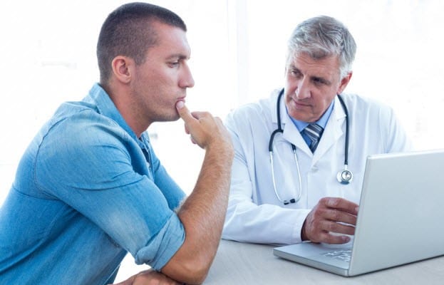 doctor speaking with patient in his office